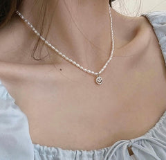 Natural pearl choker with charm