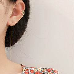 Pendientes de puño con estrella del norte dorada