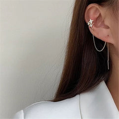 Pendientes de puño con estrella del norte dorada