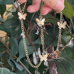 Cadena de mano con mariposa dorada