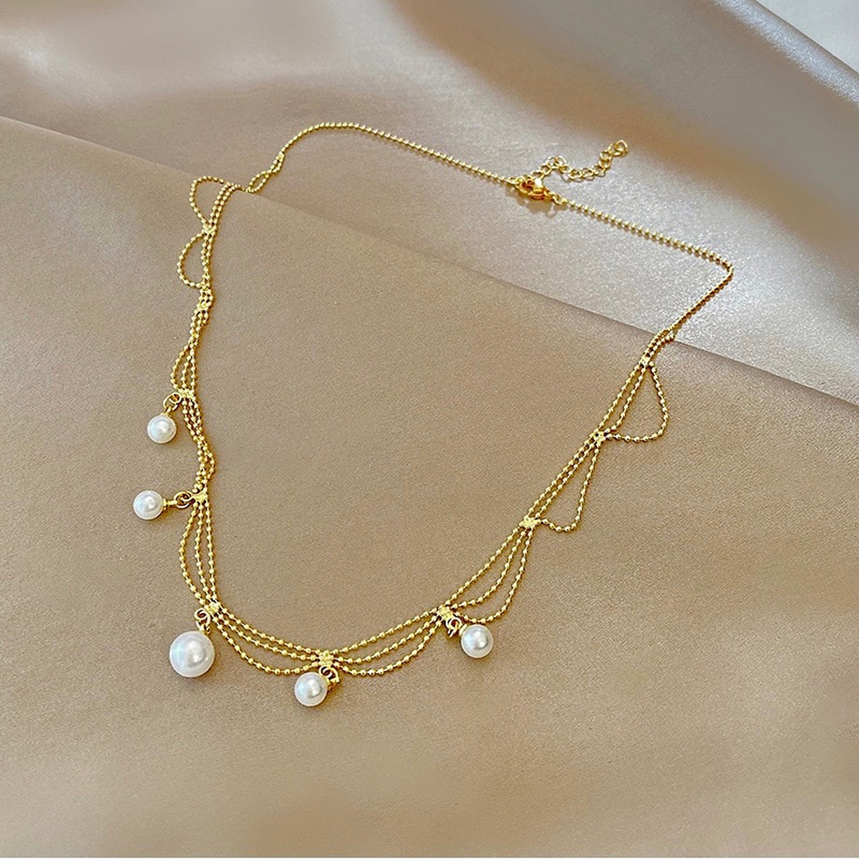 Multi layer gold pearl necklace