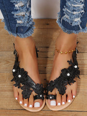 Sandalias planas con encaje floral